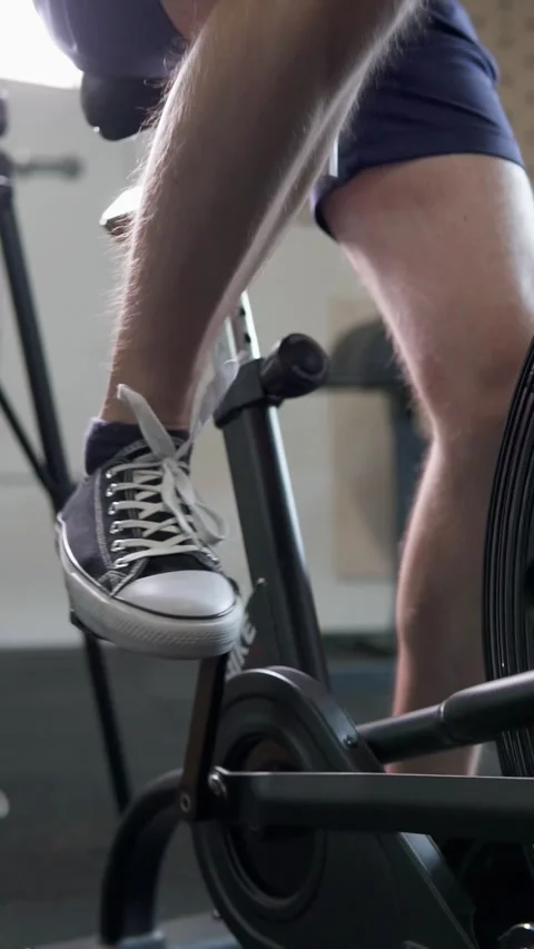 Athletic guy doing cardio workout on exercise bike. Motivation and strength. Stock Footage 302432971