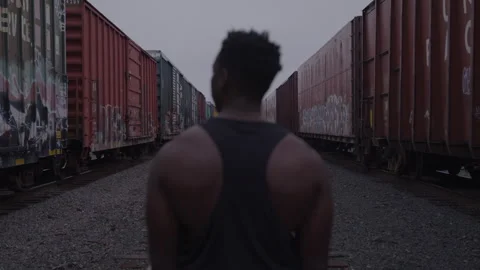 Athletic Guy Looks Around Train Yard Vídeo Stock 270327565