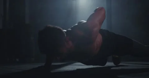 Athletic guy with a strong body doing hard push-ups in a dark cross fitness 스톡 동영상 138108745