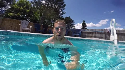 Athletic guy swimming around pool selfie pov Stock Footage 52426801