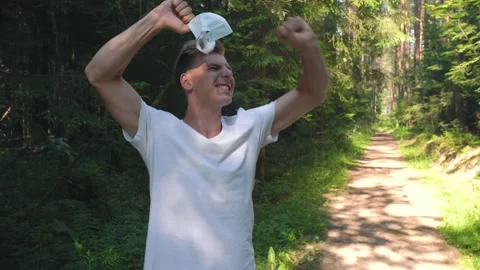 Athletic guy took off his mask and is glad that he no longer needs it. Stock Footage 157071547