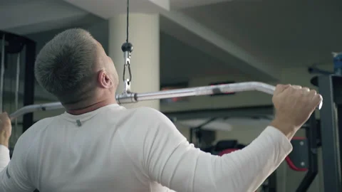 Athletic guy is training in a gym Stock Footage 147857605