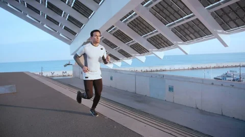 Athletic Hispanic guy do exercise scene of running outdoor at urban area in Stock Footage 105754128