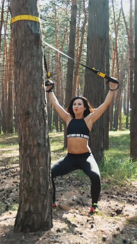 Athletic, instructor, performs exercises, doing exercises with fitness system, Stock Footage 314786183