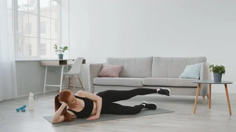 Athletic Lady Doing Side Leg Raise Exercise Lying At Home Vidéo 158237143