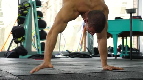 Athletic male performing dynamic hand movements on gym floor Video stock 319067766