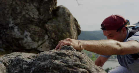 Athletic man climbing mountain, close-up hand reaching rocky grip, Stock Footage 246288072