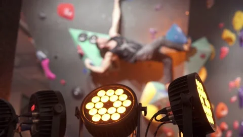 An athletic man climbs an artificial stone wall. Stock Footage 235768289