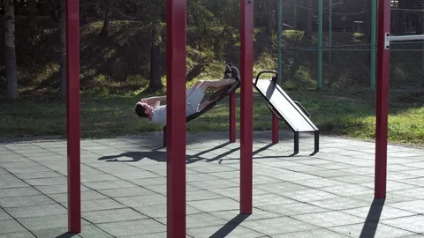 Athletic man doing active exercise workout on the outdoor street sport ground Stock Footage 94915349