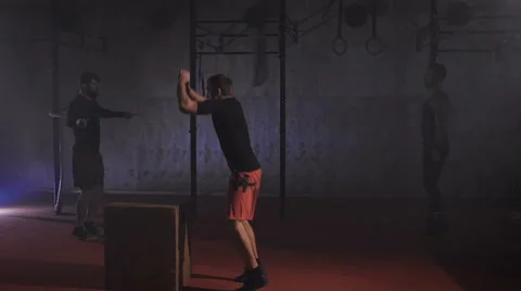 Athletic man doing backflip jump off the box and then doing frontflip on the Video stock 68776281