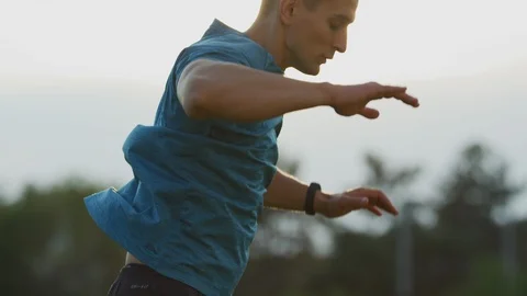 Athletic man doing burpees Stock Footage 100032185