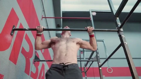 Athletic man doing butterfly pull ups in a Crossfit gym. Stock Footage 82521802