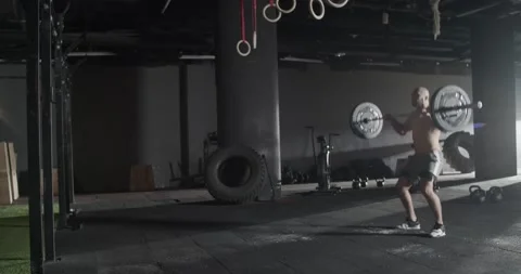 Athletic man doing clean and jerk exercise barbell in gym Stock Footage 172327807