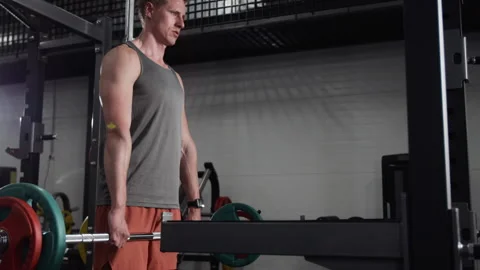 Athletic Man Doing Deadlift Workout and Checking Smartwatch in Gym Stock Footage 339885199