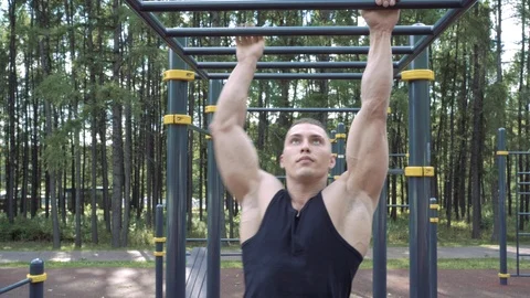 Athletic man doing exercise outdoor. Street training and physical activity Stock Footage 111864622