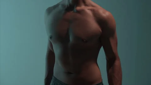 The athletic man is doing exercises with dumbbells Stock Footage 148775947