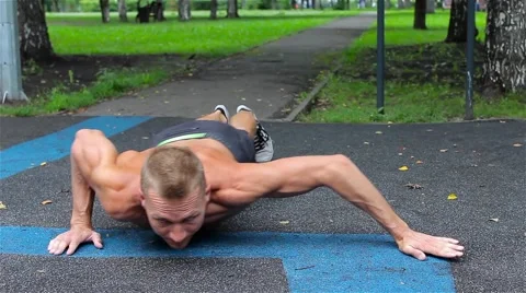 Athletic man doing gymnastics elements in City Park. workout Stock Footage 66420737