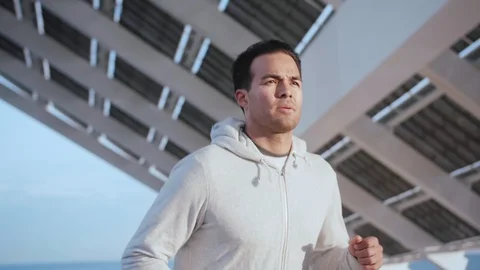 Athletic man doing motivational exercise of running outdoor at city area in Stock Footage 105754894