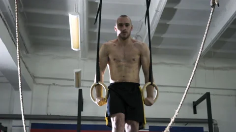 Athletic man doing muscle up exercise at the gym Stock Footage 65279026