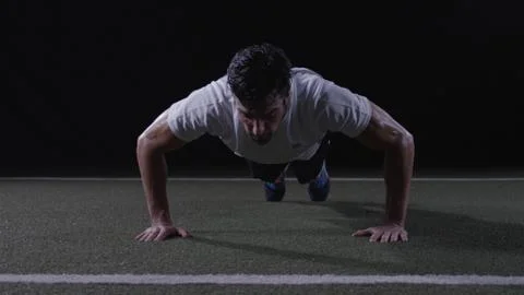 Athletic man doing a push-up Stock Photos