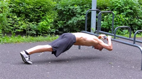 Athletic man doing push ups in City Park. side view. Workout Stock-Footage 66420709