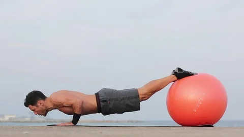 Athletic man doing push-ups on ball 動画素材 73950573