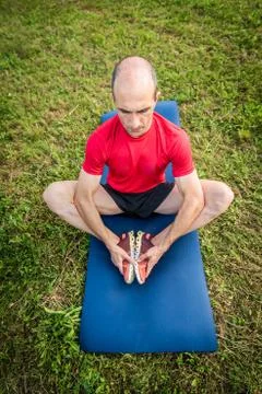 Athletic man doing stretching in nature Stock Photos