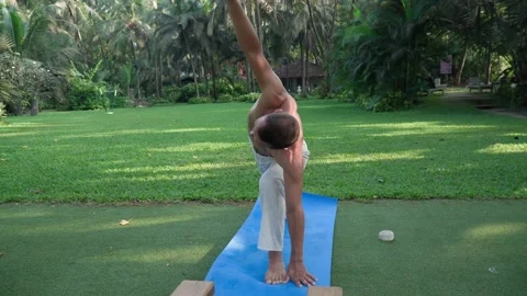Athletic man doing yoga every day Stock Footage 168493314