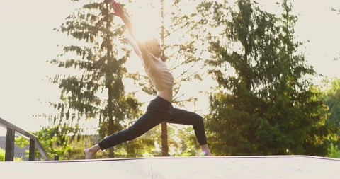 Athletic man doing yoga pose and pilates exercises in nice green park. Male Stock Footage 157992775