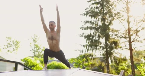 Athletic man doing yoga pose and pilates exercises in nice green park. Male Stock Footage 157992895