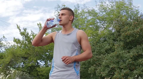 Athletic man drinking clean water from a bottle Stock Footage 65482061