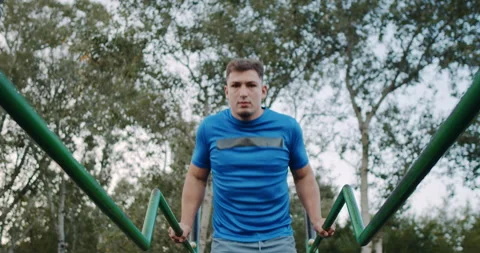 An Athletic Man Engaged in Performing PushUps Outside in a Beautiful Natural Stock Footage 317980637