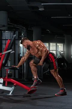 Athletic man is engaged in strength training focusing on his upper body using Stock Photos