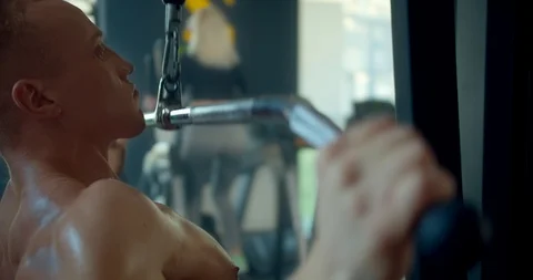 Athletic man engages in lat pulldowm machine in the gym Stock Footage 127320118