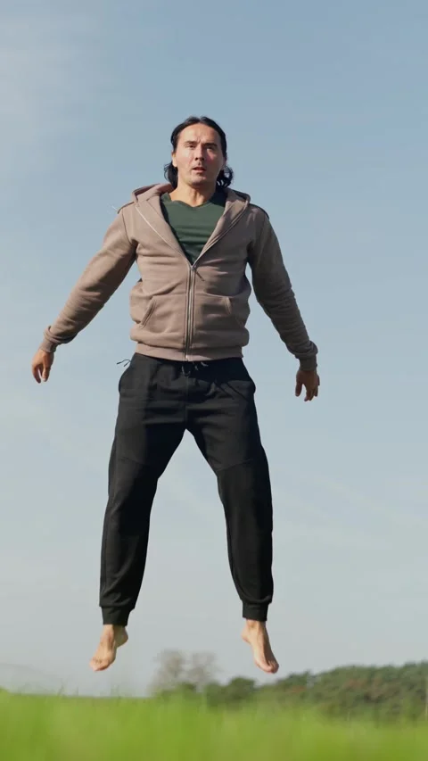 An Athletic Man Engaging in Squats while Surrounded by the Beautiful Nature Stock Footage 302655606