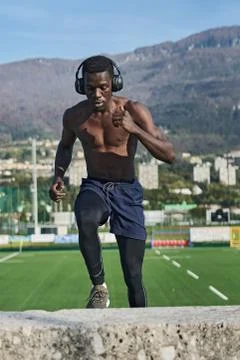 Athletic man exercising in front of mountains Stock Photos