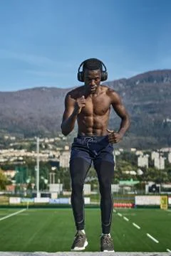 Athletic man exercising in front of mountains Stock Photos