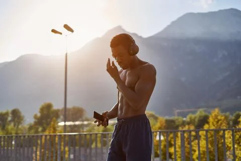 Athletic man exercising in front of mountains Stock Photos