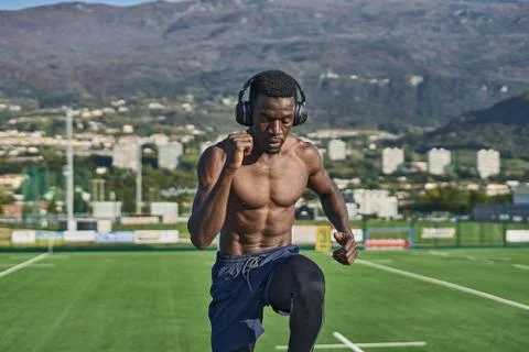 Athletic man exercising in front of mountains Stock Photos