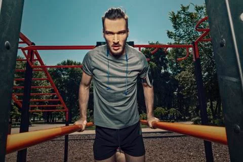 Athletic man exercising in the park. Stock Photos