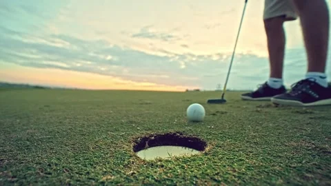 Athletic Man at Golf Course Playing Game and Hitting Ball in Hole with Club Stock-Footage 257409887