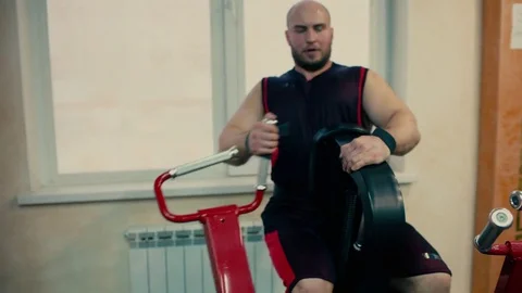 Athletic man in a gym working on a simulator Stock Footage 81278137