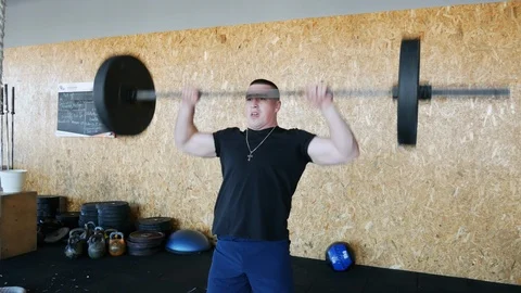 Athletic man hard working in the gym, trains with barbell, crossfit training Stock Footage 102065136