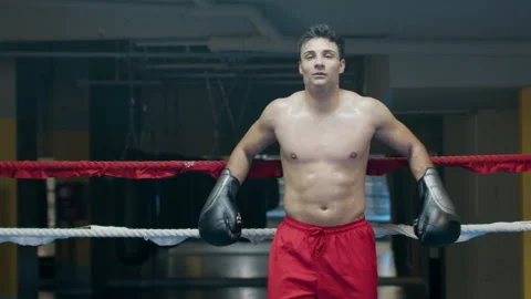 Athletic man leaning on boxing ring ropes Stock-Footage 181784059