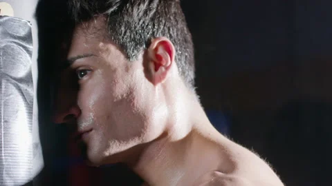 Athletic man leaning his forehead to sandbag while having break Stock Footage 181785986
