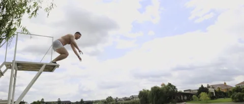 Athletic man leaping from a high diving board Stock Footage 203800627