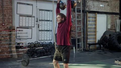 An athletic man is lifting weights Stock Footage 155557098