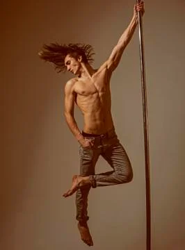 Athletic man make acrobatic elements on pylon. dieting. sexy macho dancer Stock-Fotos