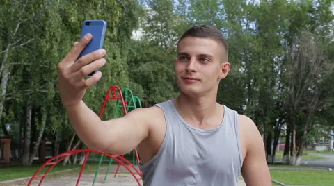 Athletic man make a photo use smartphone in the outdoors Stock Footage 65524528