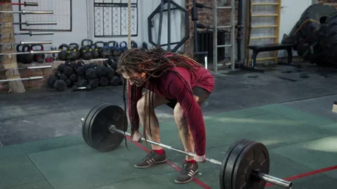 An athletic man is making an exercise with a barbell Video stock 156302525